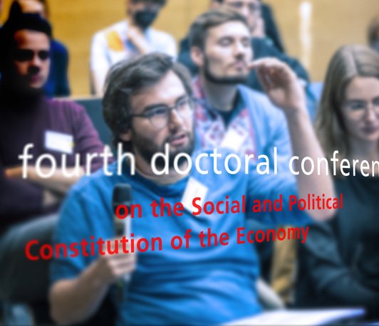 Image of audience discussion with name of conference