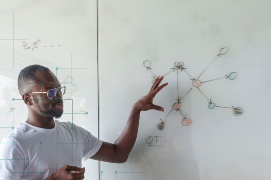 Person explaining something at whiteboard