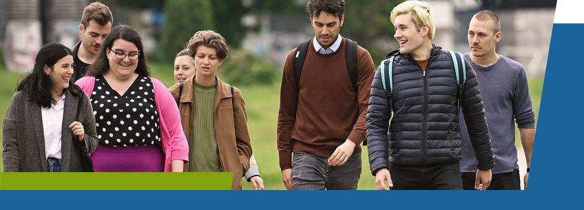 Group of young adults walking outdoors, dressed casually. Group of young adults walking outdoors, dressed casually.