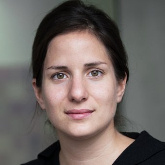 © MPIfG / Dünkelmann A woman with light brown skin and dark hair is looking directly at the camera, wearing a black top.