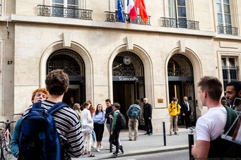 Young people chatting in front of building in Paris
