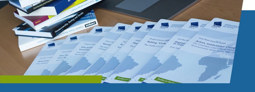 IMPRS-SPCE, Dissertations A collection of printed reports or booklets arranged in a row, with additional books stacked on the left and a laptop visible in the background.